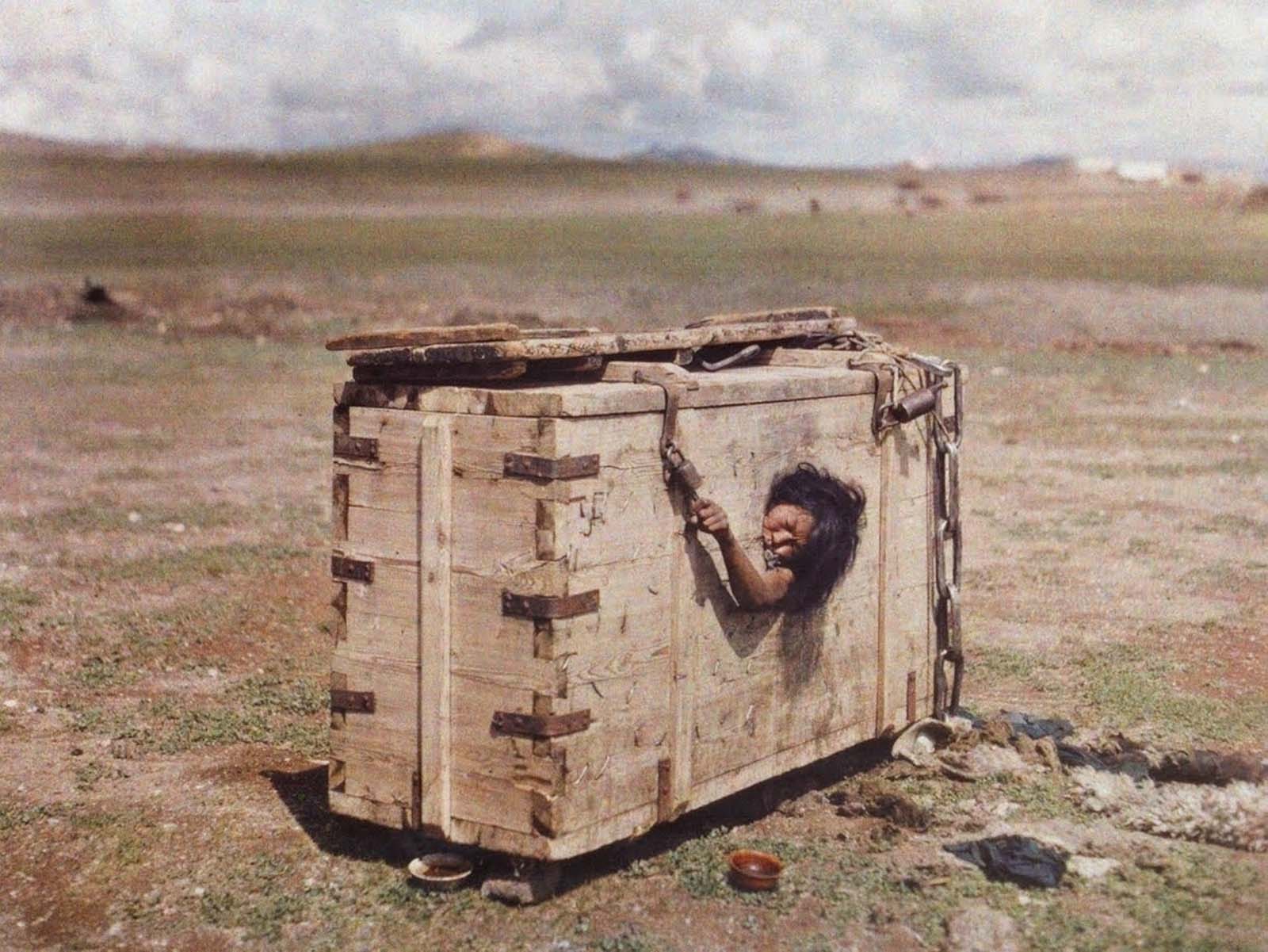 Une femme de nationalité mongole atteint depuis le hublot d'une caisse dans laquelle elle est emprisonnée, 1913
