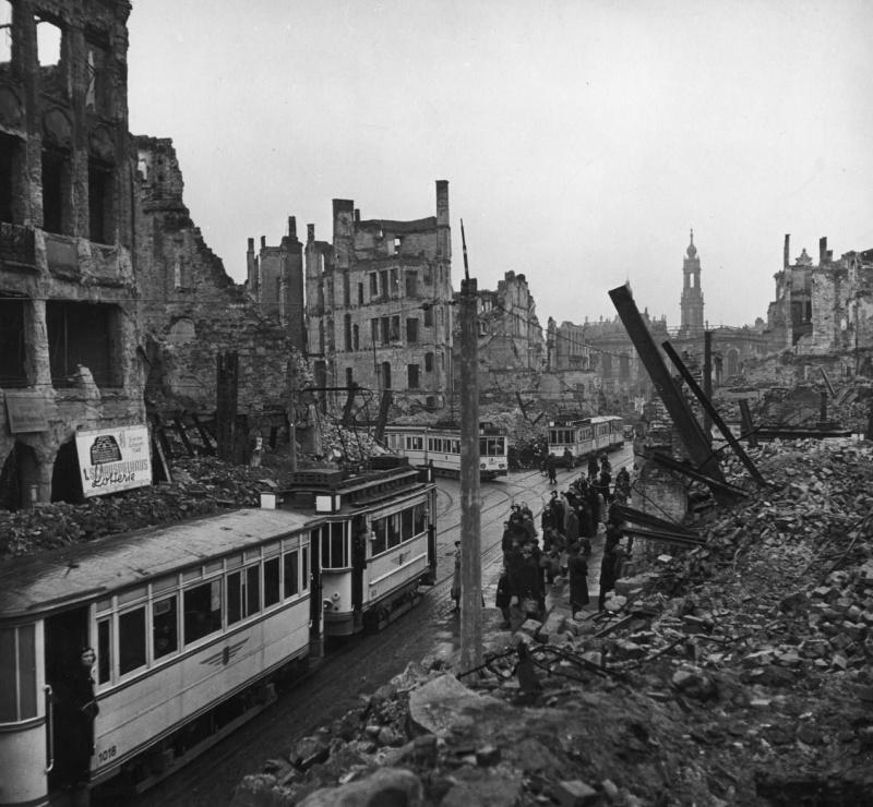 Les citadins à l'arrêt de tramway de la rue en ruines de Dresde